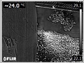 Infrared view of a building showing a temperature gradient. Warmer area near roof, cooler on the left.