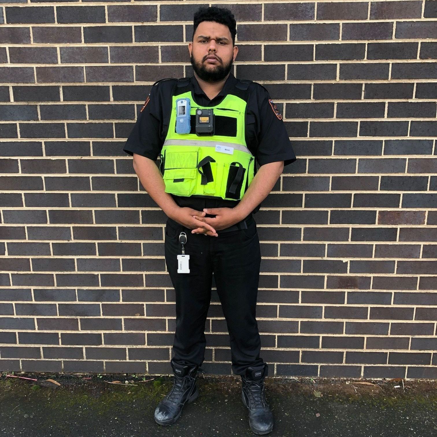 security guard sitting in front of security camera display