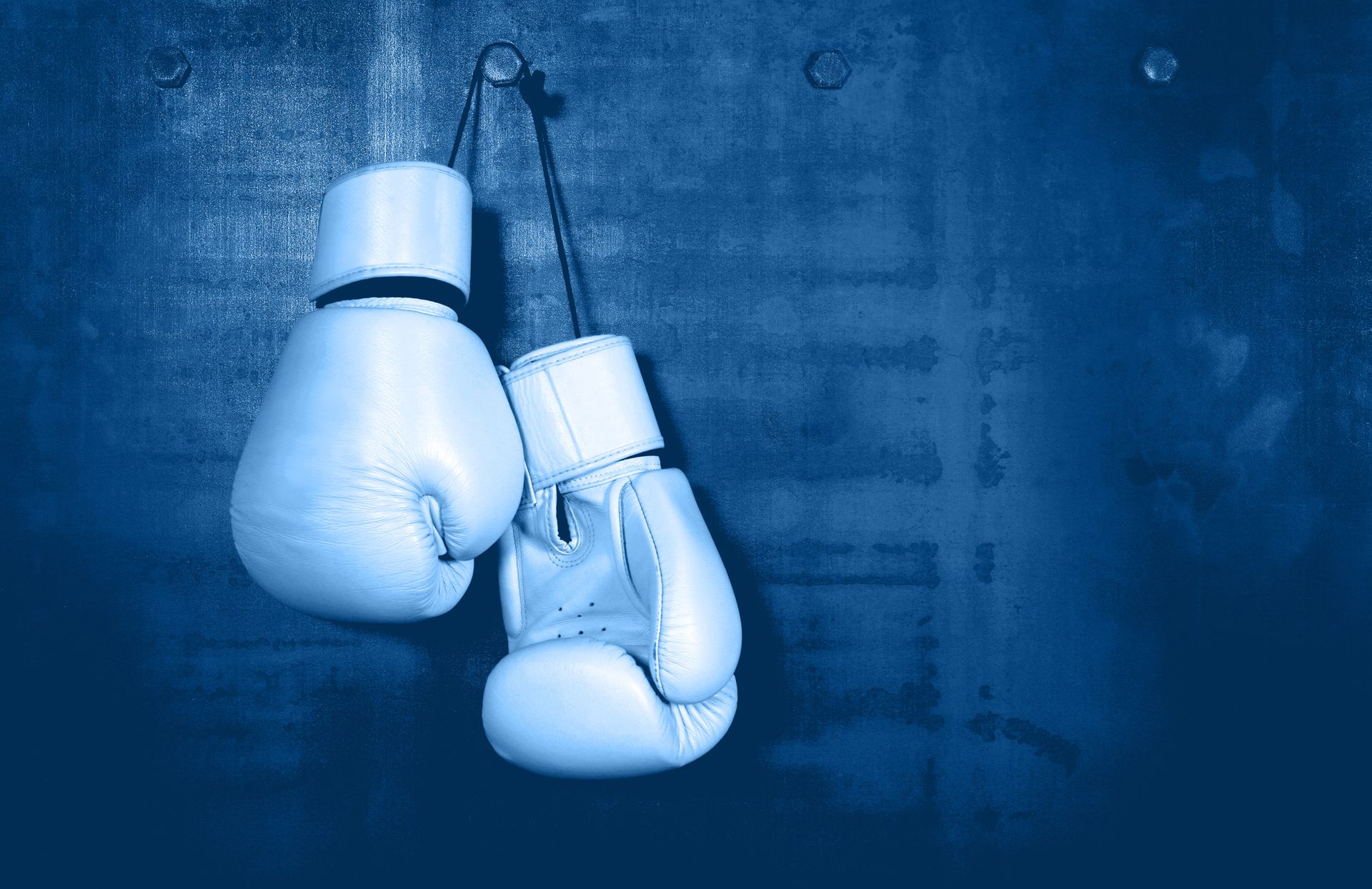 Boxing Gloves Hanging On Blue Wall - Brunswick VIC - CityWatch Security Boxing Gloves Hanging On Blue Wall - Brunswick VIC - CityWatch Security